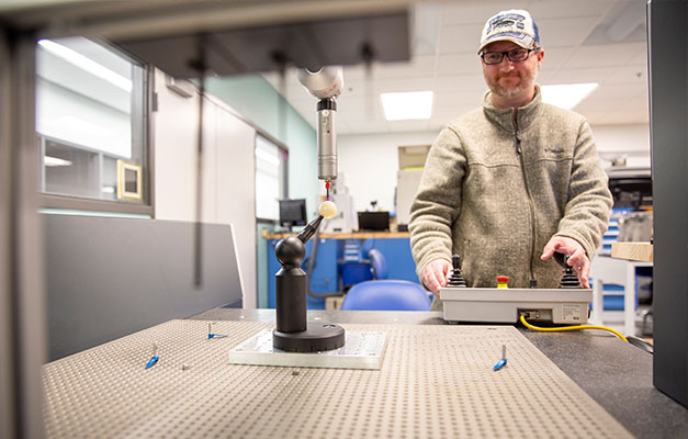 A Quality Inspector Student Using Equipment to Work on a Project. 