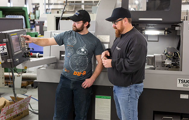 A Student and Professor Using a Machine.