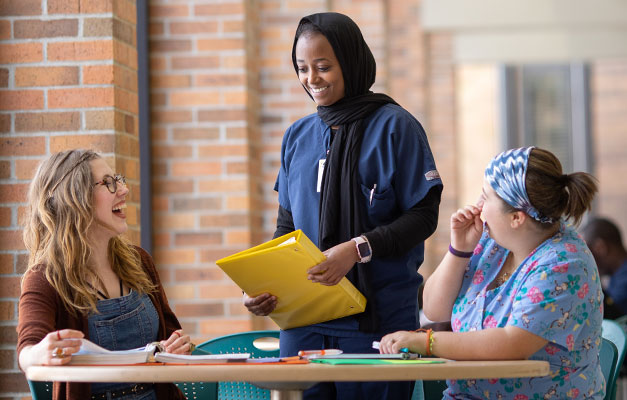 Three Students Meeting in the Cafeteria 