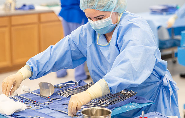 Sterile Processing Student Preparing Equipment for a Test. 