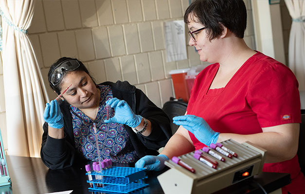 Medical Assistant Students Inspecting a Vile. 